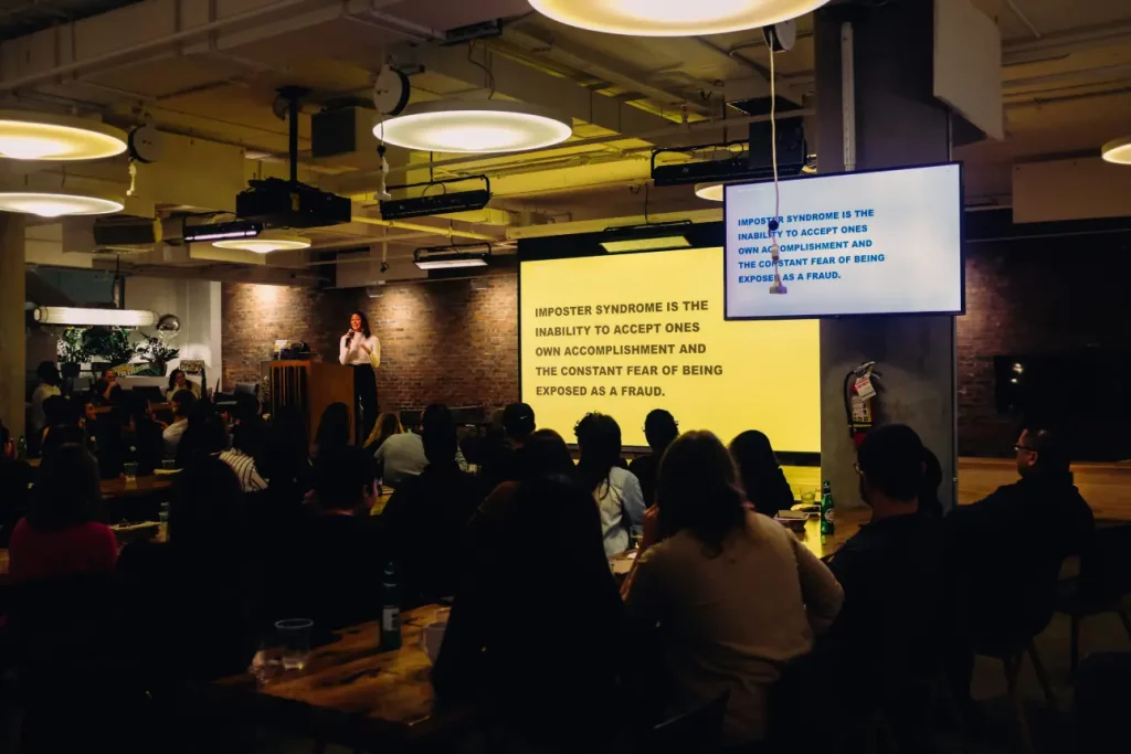woman presenting infront of a large group of people